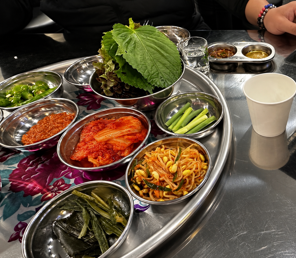 Korean barbecue side dishes served with grilled beef