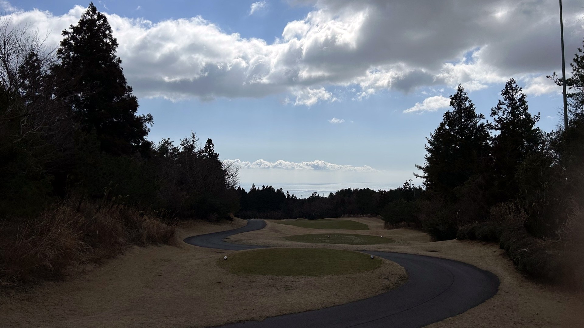 Golf course hole in Jeju with a lake and ocean view